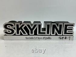 The Skyline Nissan Symbol of 25 Years of Quality Emblem figure Rare Japan Post