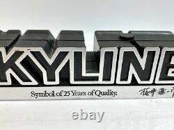 The Skyline Nissan Symbol of 25 Years of Quality Emblem figure Rare Japan Post